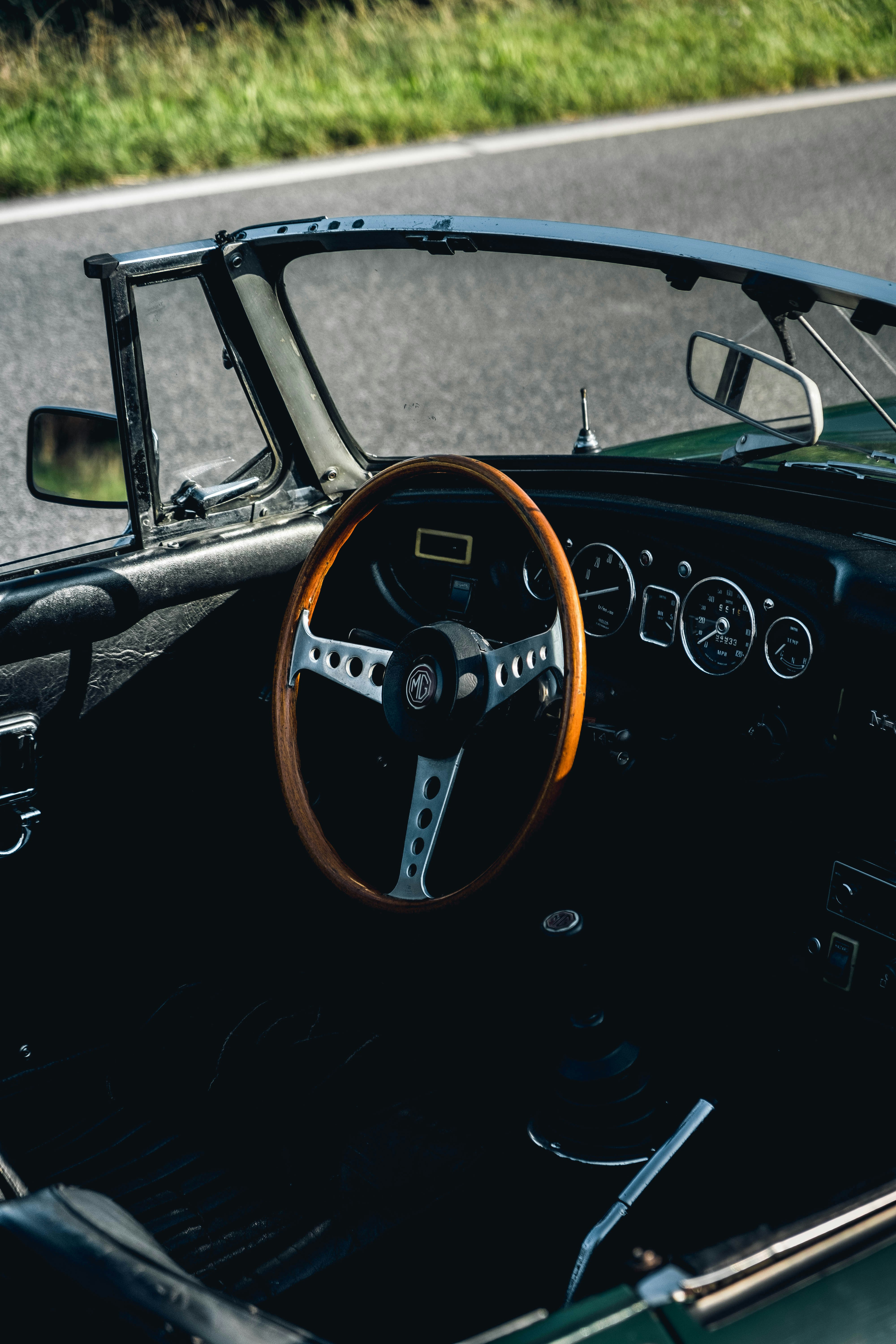 black car on gray asphalt road during daytime